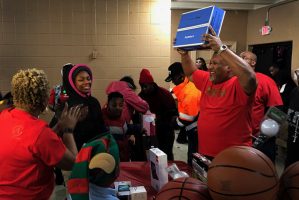 Joyful atmosphere and a happy recipient of Ankin Law Toy Drive