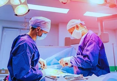 Group of surgeons in operating room performing a surgery.