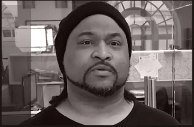 Man with beard wearing a bonnet and shirt concerns about medical malpractice.