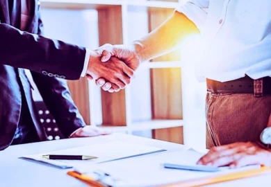a handshake between men after one man hires the other as his personal injury lawyer.