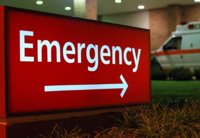 Ambulance sitting behind ER sign