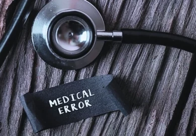 MEDICAL ERROR word written on label tag with Stethoscope on wood background. common types of surgical errors