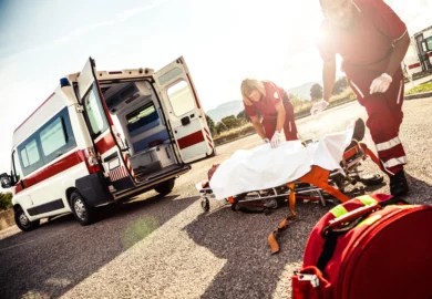 Emergency response team taking an injured driver after an accident.