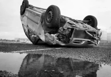 Rollover car in the middle of a highway.