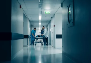 Nurses and doctors rushing a patient to the emergency room.