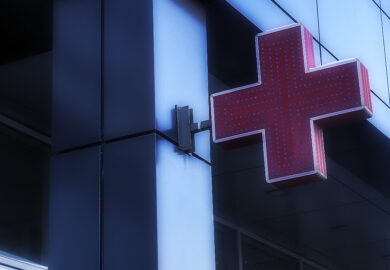 A red cross signage of a hospital.