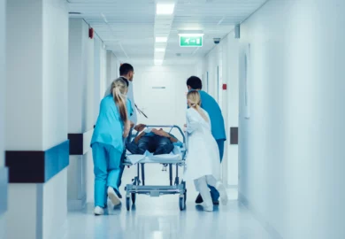 Doctors and nurses rushing a patient to the emergency room.