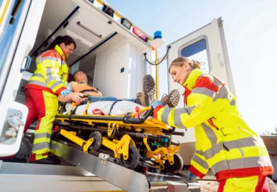 Patient being carried in the ambulance.
