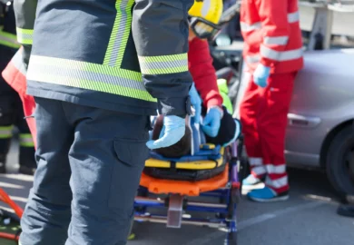 Paramedics taking the injured driver with stretcher.