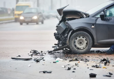 Black car involved in a frontal collision accident.