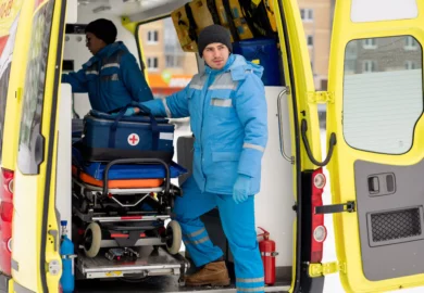 Paramedics preparing their stuff to the ambulance.