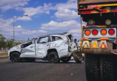 Wrecked white SUV on the road.