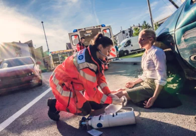 Paramedic aiding an injured woman.