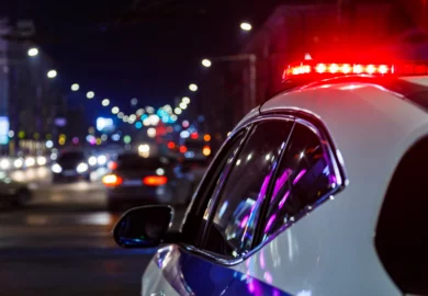 Police car with lights on the street.