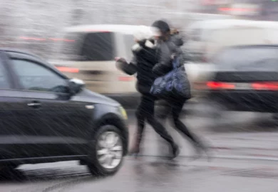 Pedestrians rushing to cross the street.