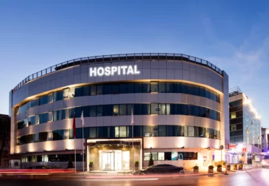 Hospital with cars on the street.