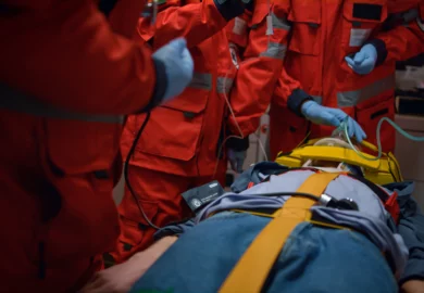 Paramedics aiding an injured man.