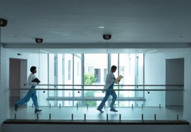 Two hospital staff rushing to the emergency room.