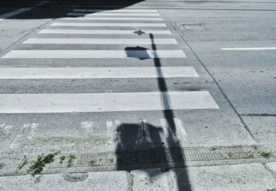 Pedestrian lane with traffic light shadow.