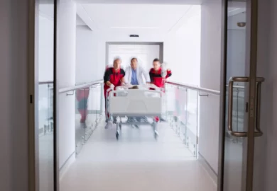 Doctor and two paramedics rushing a patient to the emergency room.