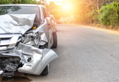 Wrecked silver SUV after a frontal collision.