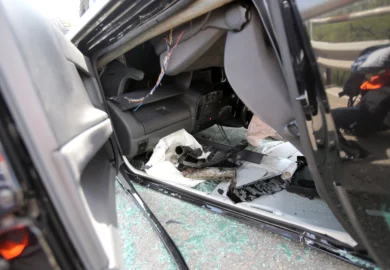 Roll-over black sedan car after a collision.