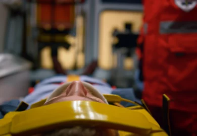 Injured man on a stretcher inside an ambulance.