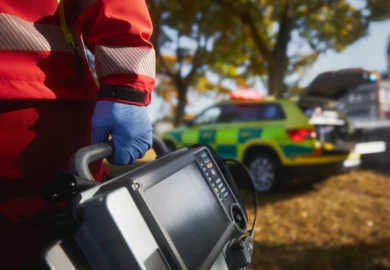 Paramedics holding a defibrillator.